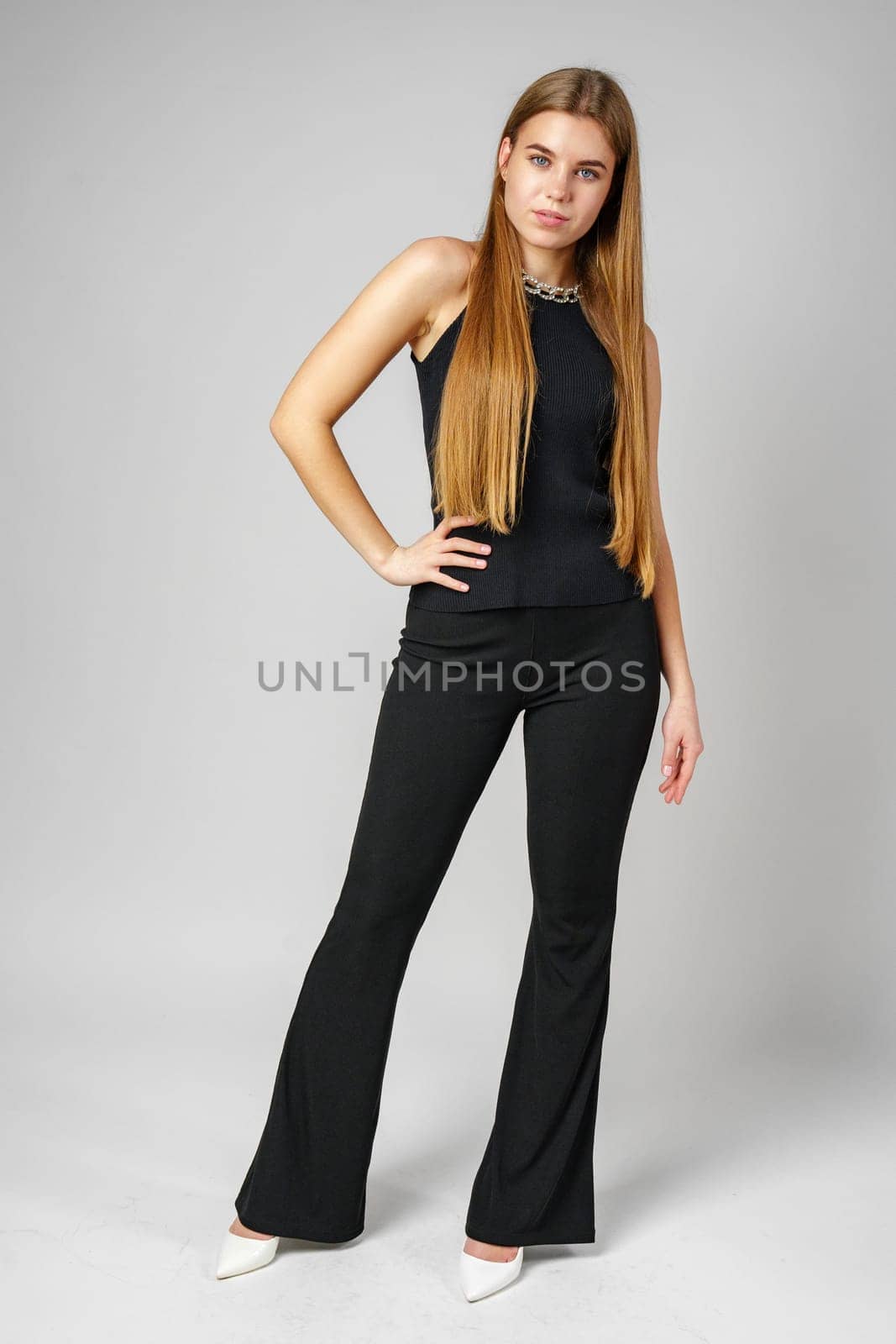 Young Woman With Long Hair in Black Pants and Top