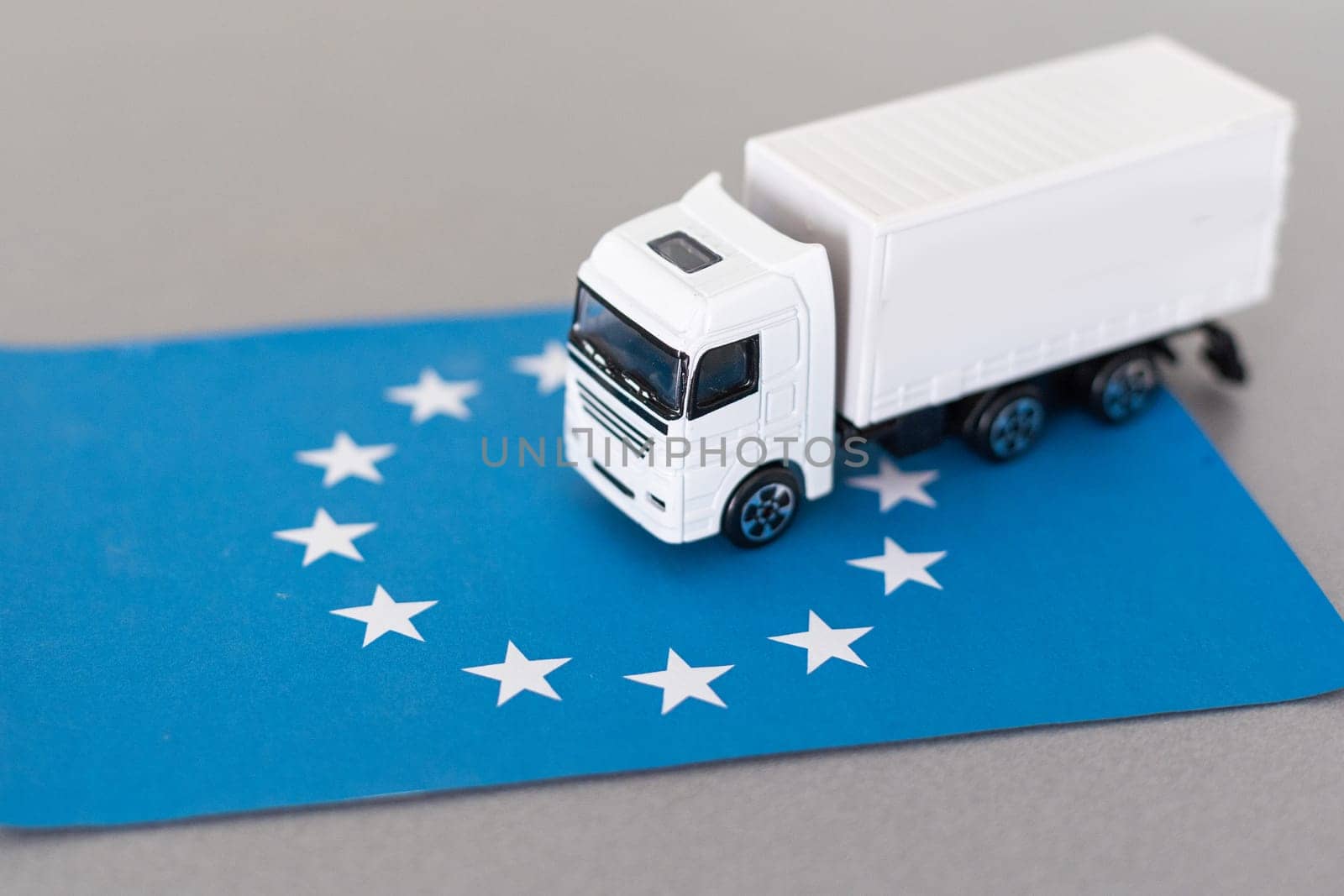 Truck on the European Union flag. Cargo Delivery in the EU concept, 3D rendering by Andelov13