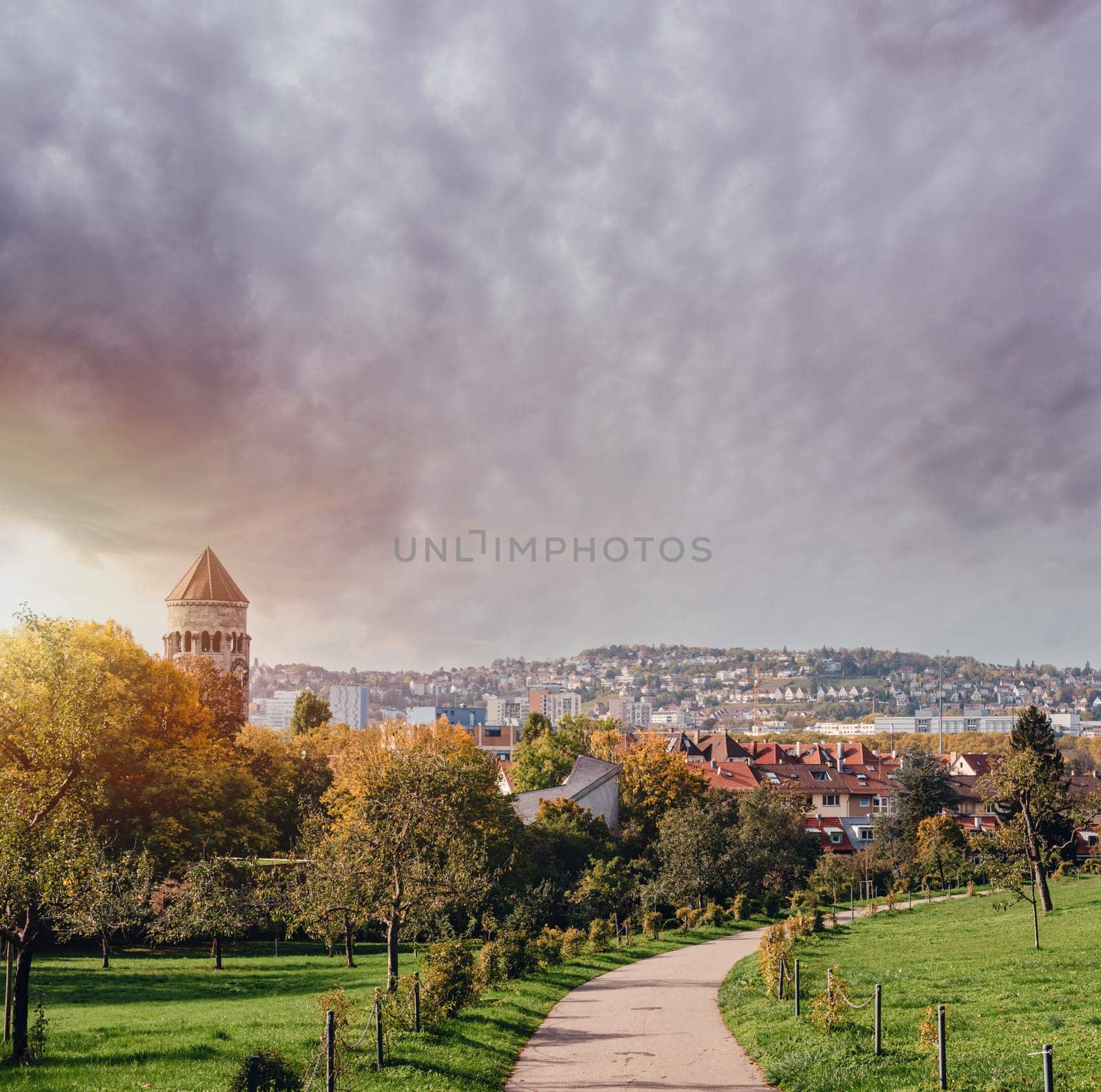 Germany, Stuttgart panorama view. Beautiful houses in autumn, Sky and nature landscape. Vineyards in Stuttgart - colorful wine growing region in the south of Germany with view over Neckar Valley. Germany, Stuttgart city panorama view above vineyards, industry, houses, streets, stadium and highway at sunset in warm orange light.