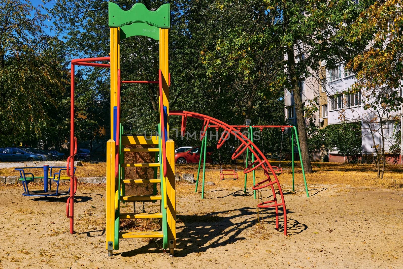 Summer spring children's playground with painted toy slide in park by jovani68