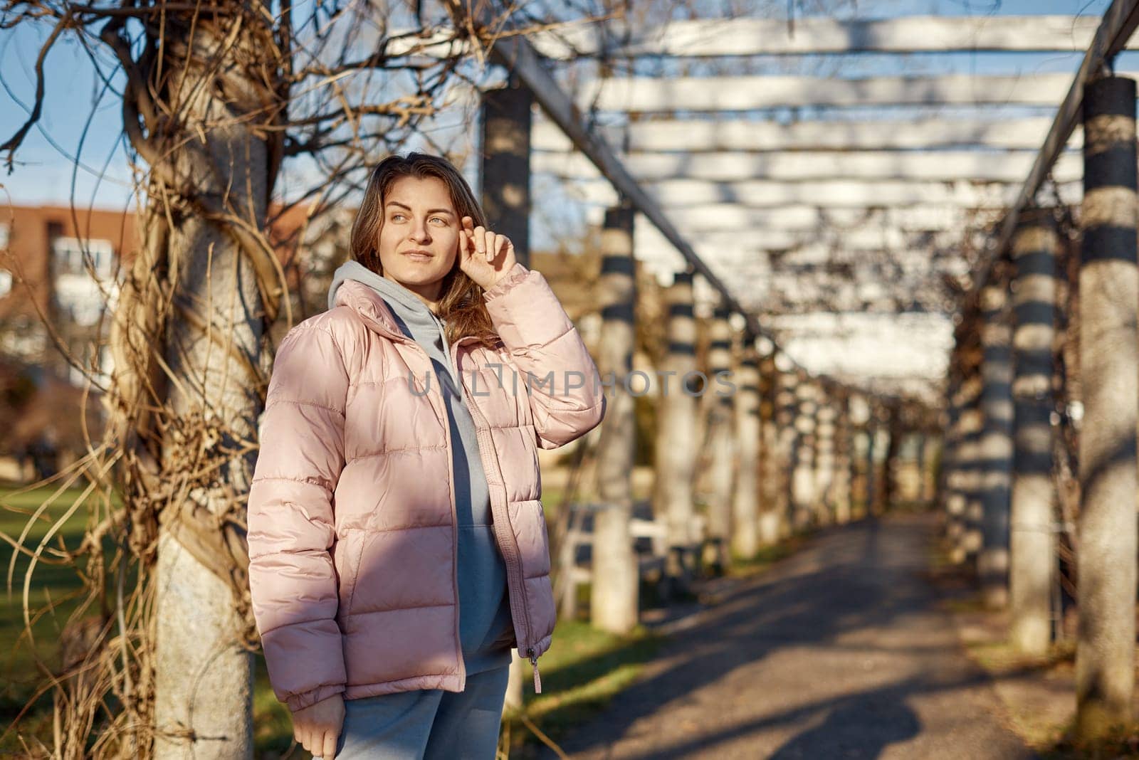 Winter Fun in Bitigheim-Bissingen: Beautiful Girl in Pink Jacket Amidst Half-Timbered Charm. a lovely girl in a pink winter jacket standing in the archway of the historic town of Bitigheim-Bissingen, Baden-Wurttemberg, Germany. by Andrii_Ko