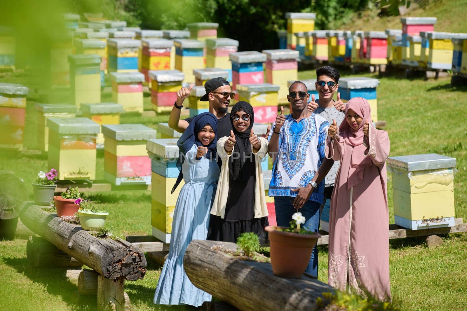 A diverse group of young friends and entrepreneurs explore small honey production businesses in the natural setting of the countryside