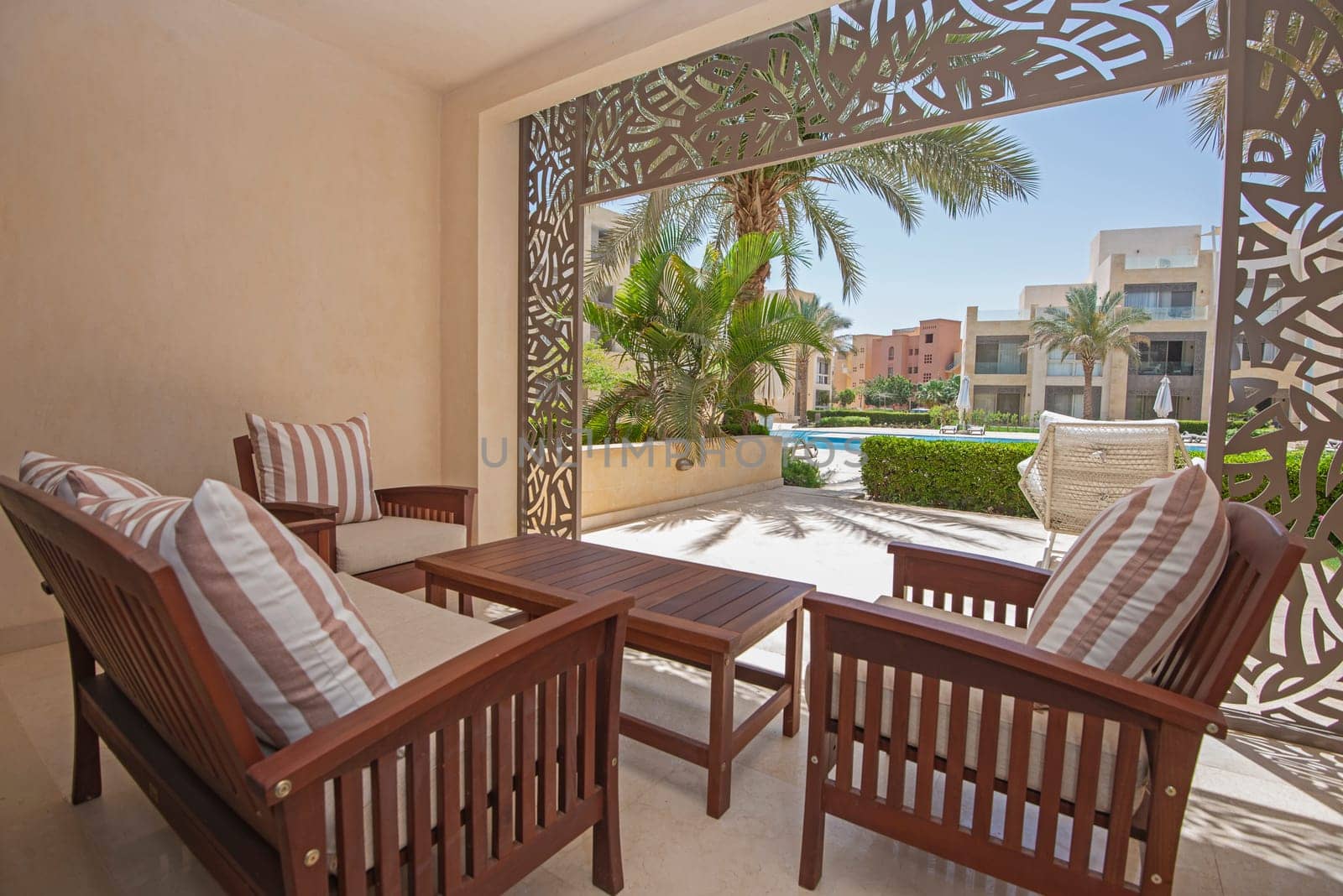 Patio terrace garden with chairs in tropical luxury apartment resort by paulvinten