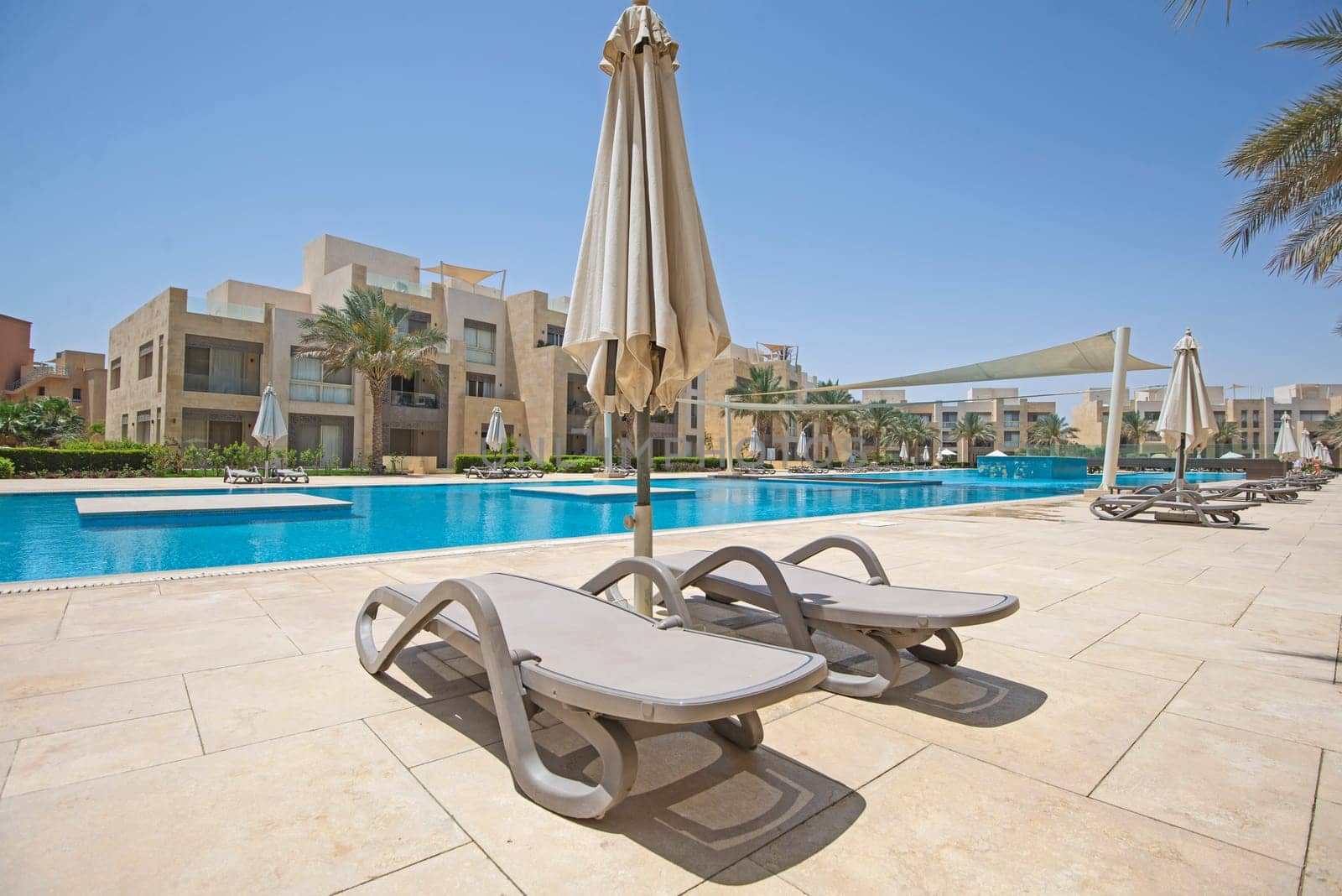 Swimming pool in tropical luxury apartment resort by paulvinten