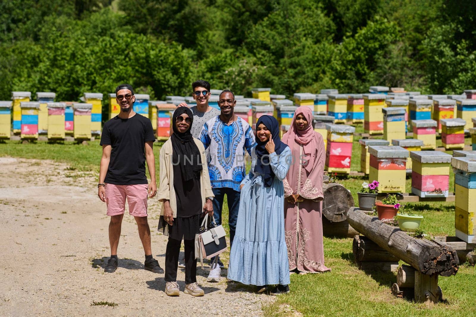 A diverse group of young friends and entrepreneurs explore small honey production businesses in the natural setting of the countryside