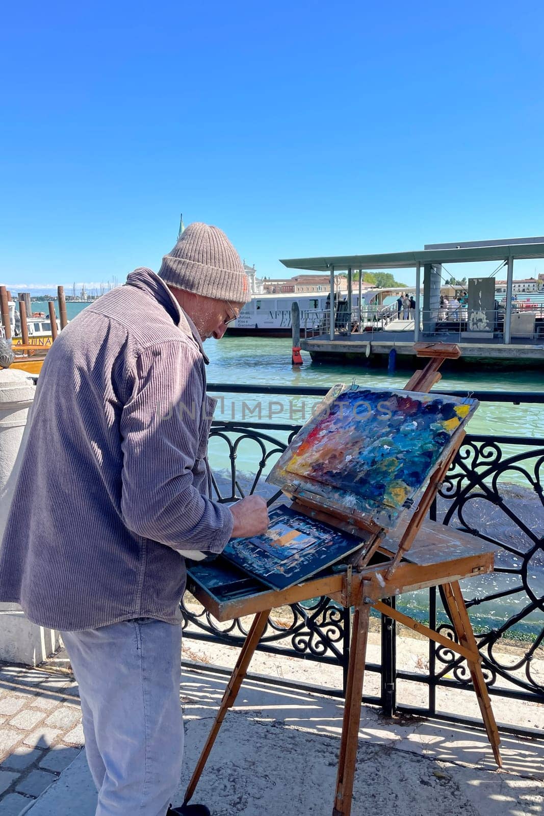 Italy, Venice, April 25, 2024. An artist paints pictures for tourists on the streets of Venice. High quality photo