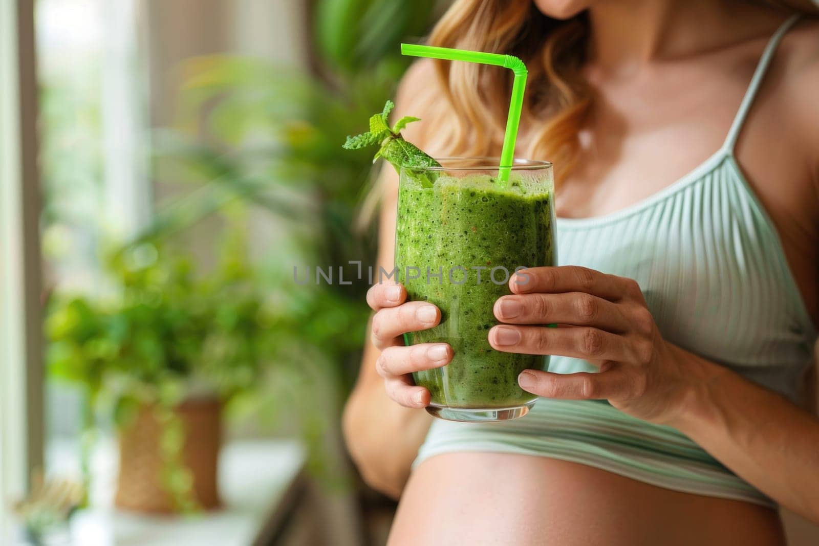 happy pregnant woman drinking green vegetable juice or smoothie at home. ai generated by Desperada