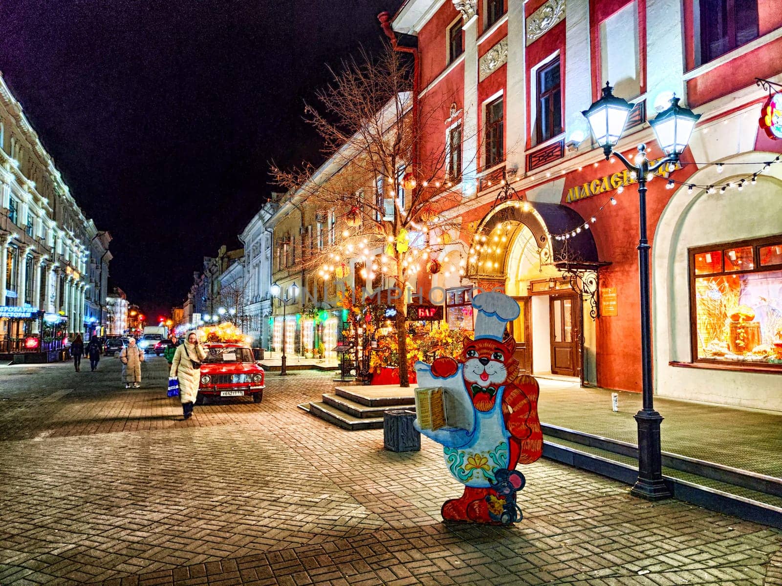 Kazan, Russia - November 16, 2023: Nighttime Stroll. Illuminated Bauman Street bustling with evening activity under glowing lights