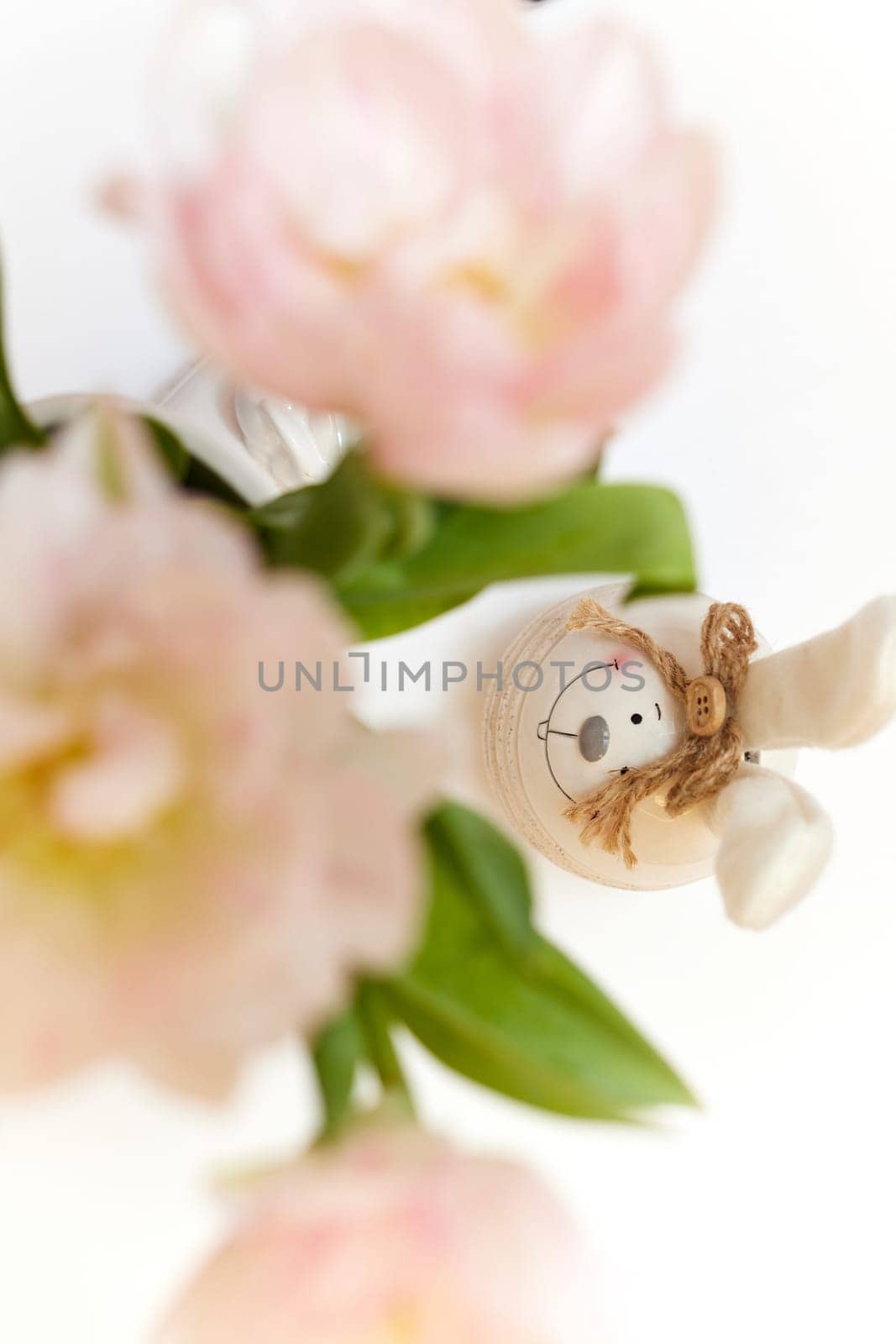 bouquet of tulips and Easter bunny on white table by erstudio