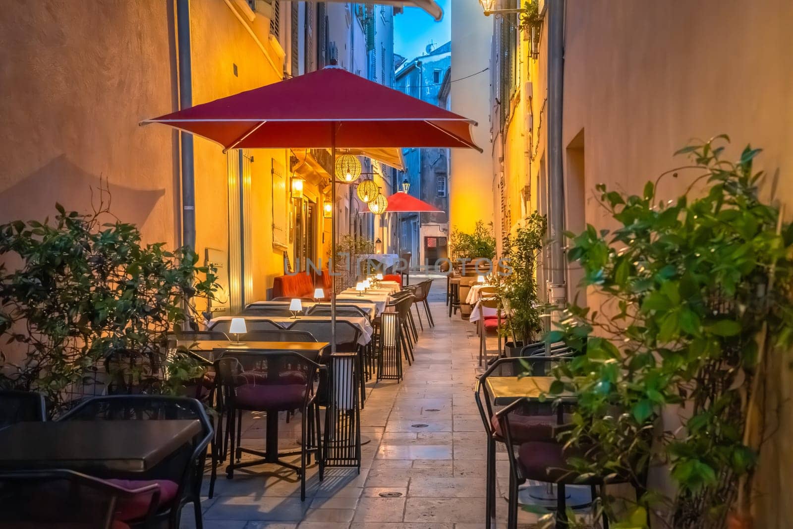 Saint Tropez stone alley with restaurants evening view, luxuty travel destination in southern France