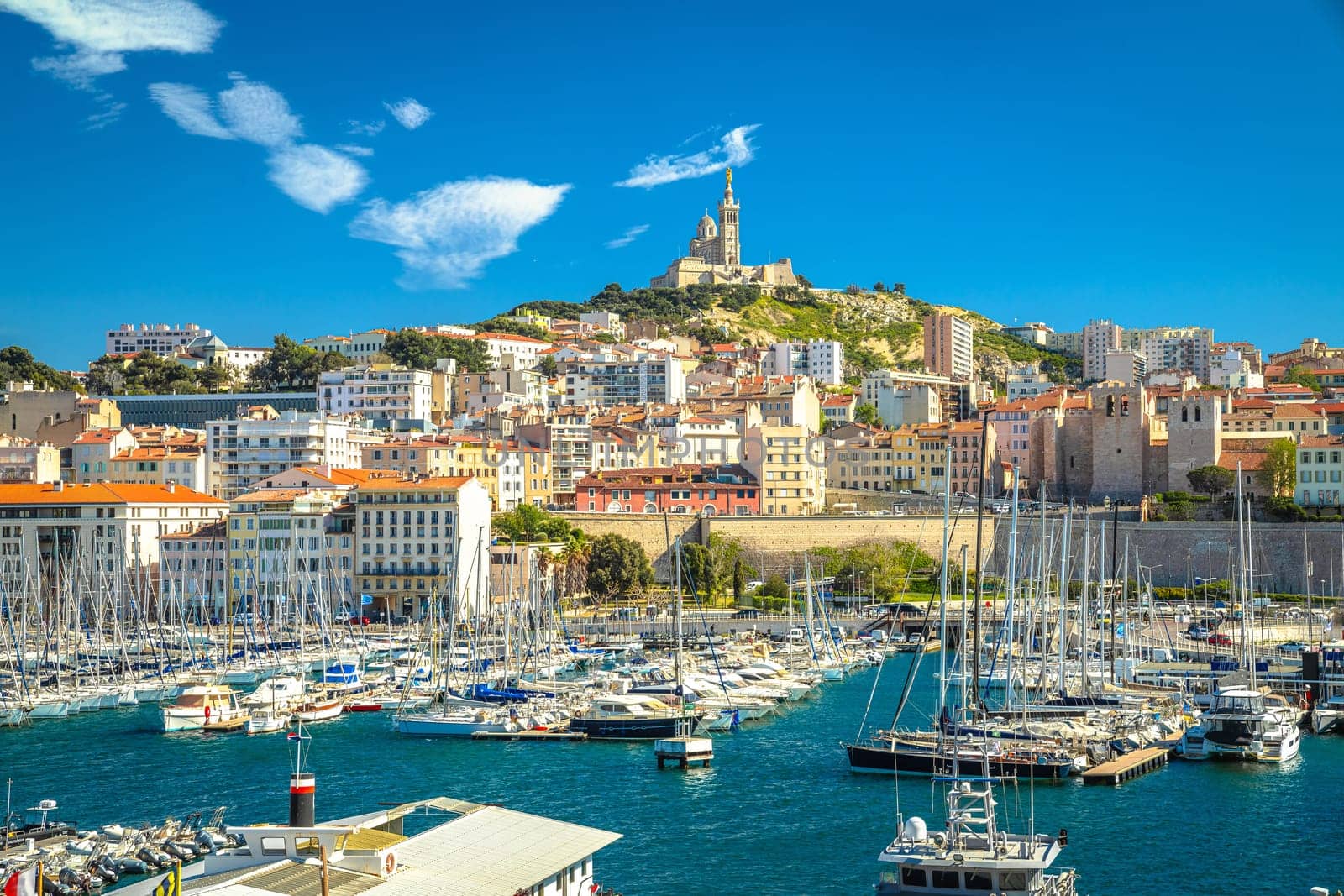 City of Marseille harbor and Notre Dame de la Garde church on the hill view, southern France
