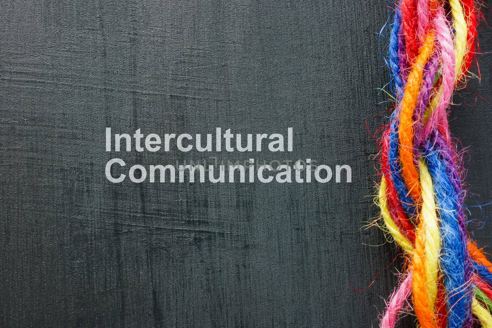 Intercultural communication concept. Multicolored threads twisted into one rope.