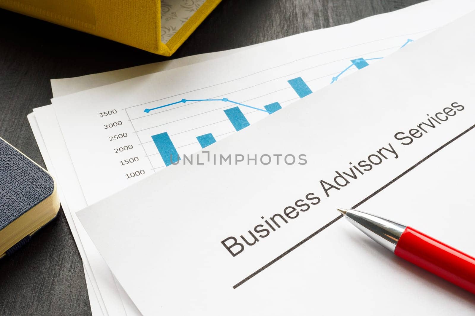 Business advisory services concept. A stack of financial charts and folder.