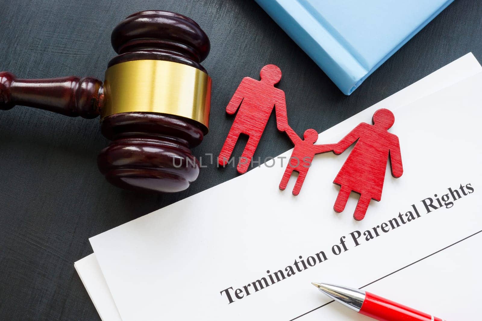 Documents about Termination of parental rights and wooden family figurines.