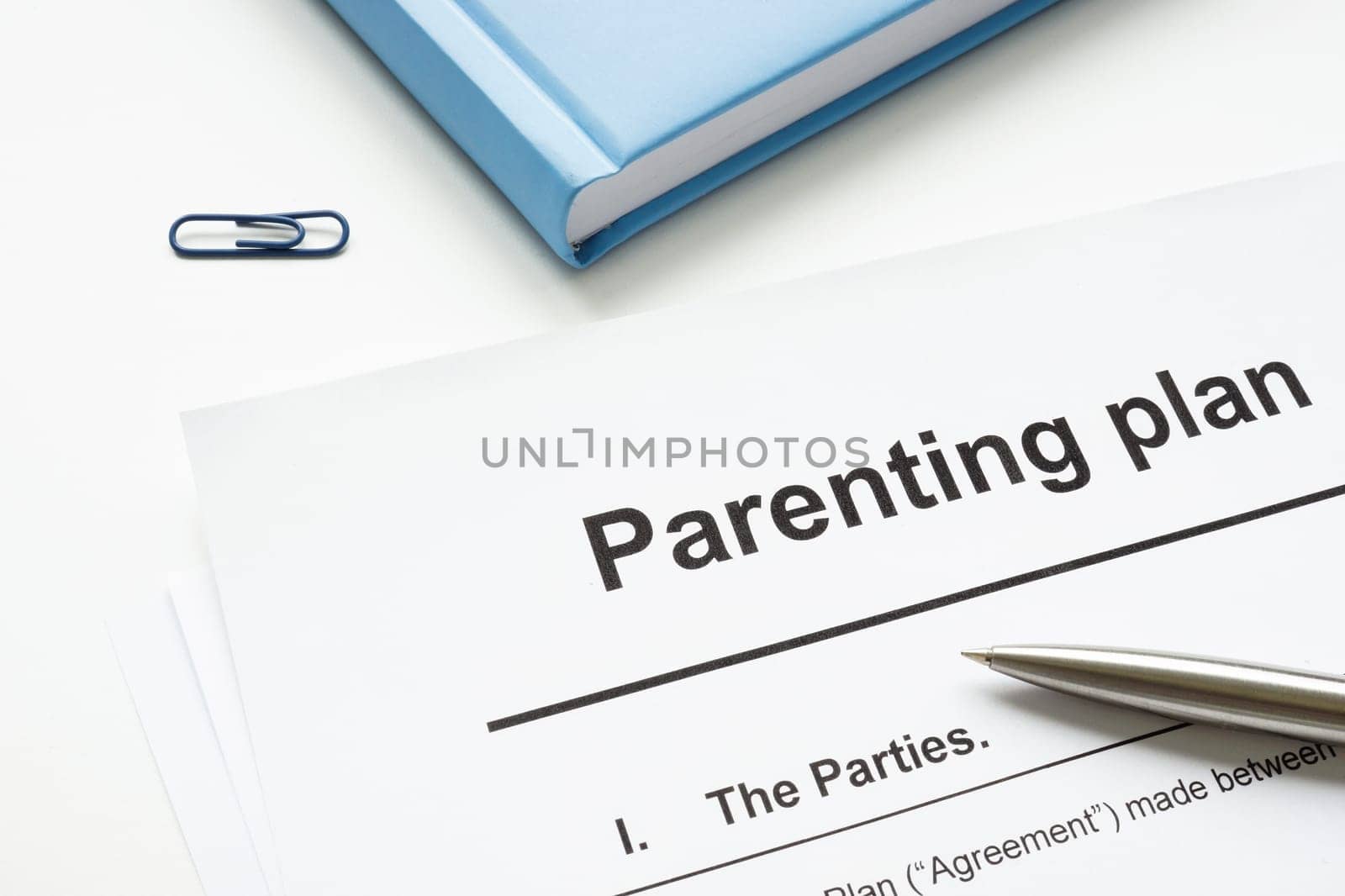 Parenting plan document and pen for signature. by designer491