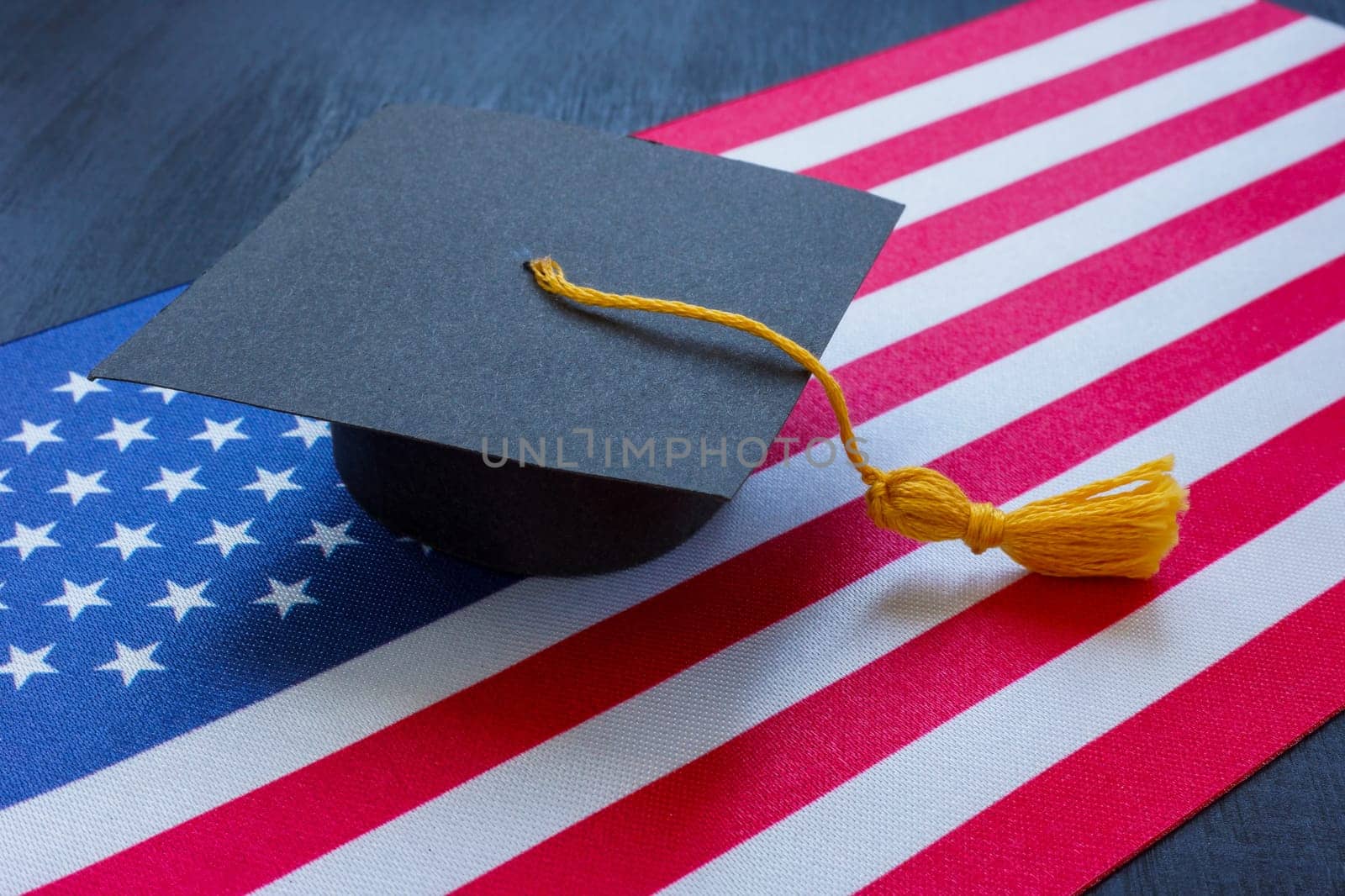 Student hat on the US flag as symbol of education.