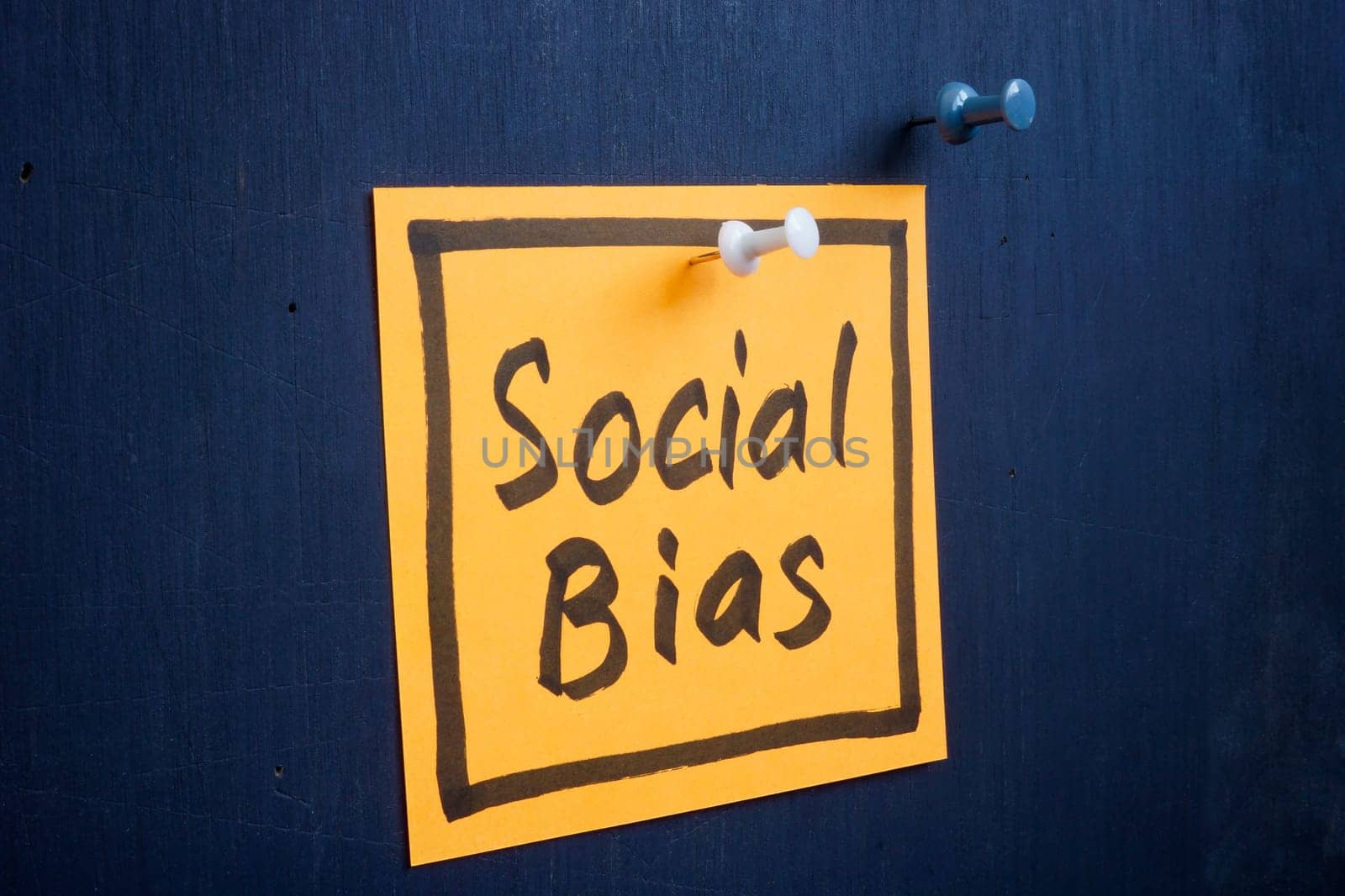 Piece of paper with an inscription social bias is pinned to the board.