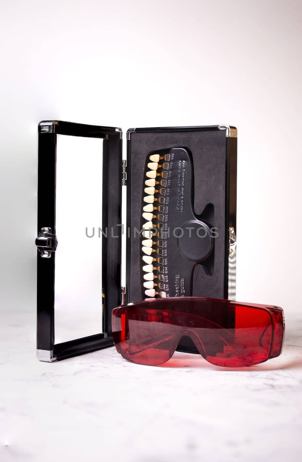 Dental equipment for the selection of the shade and color of teeth in close-up on a white background.