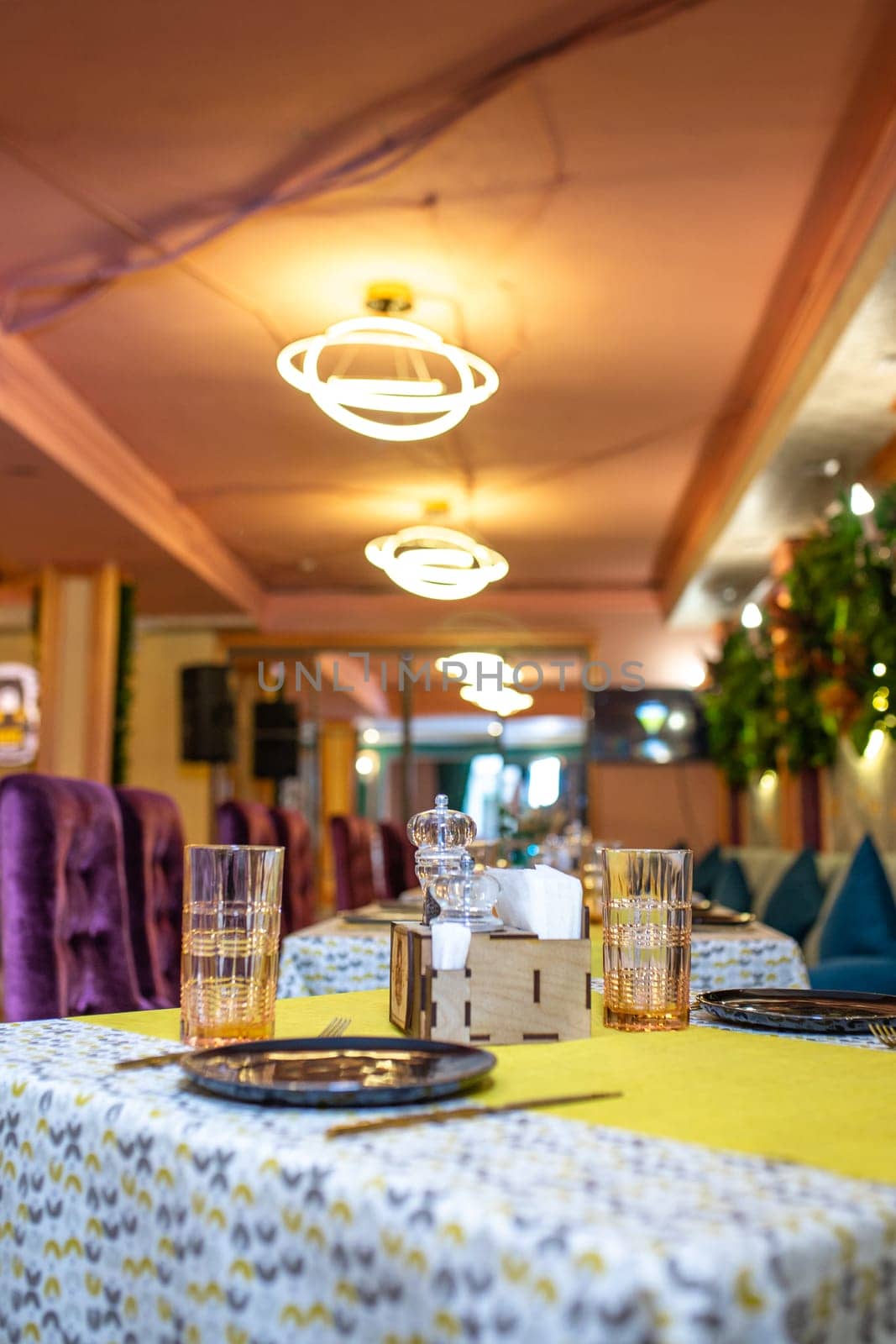 Served table in a family restaurant with a bright interior by Pukhovskiy