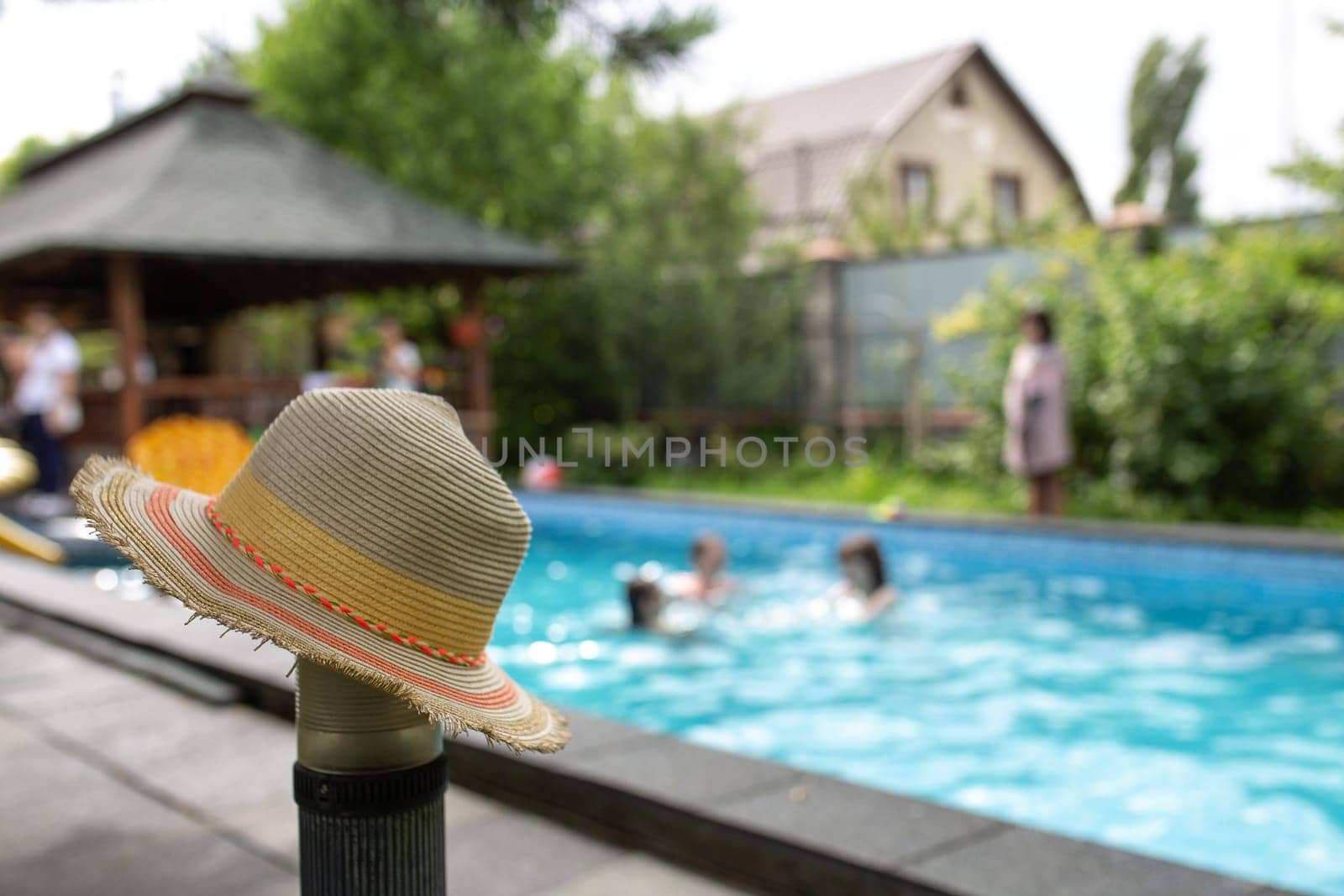 hat on the background of a pool party.