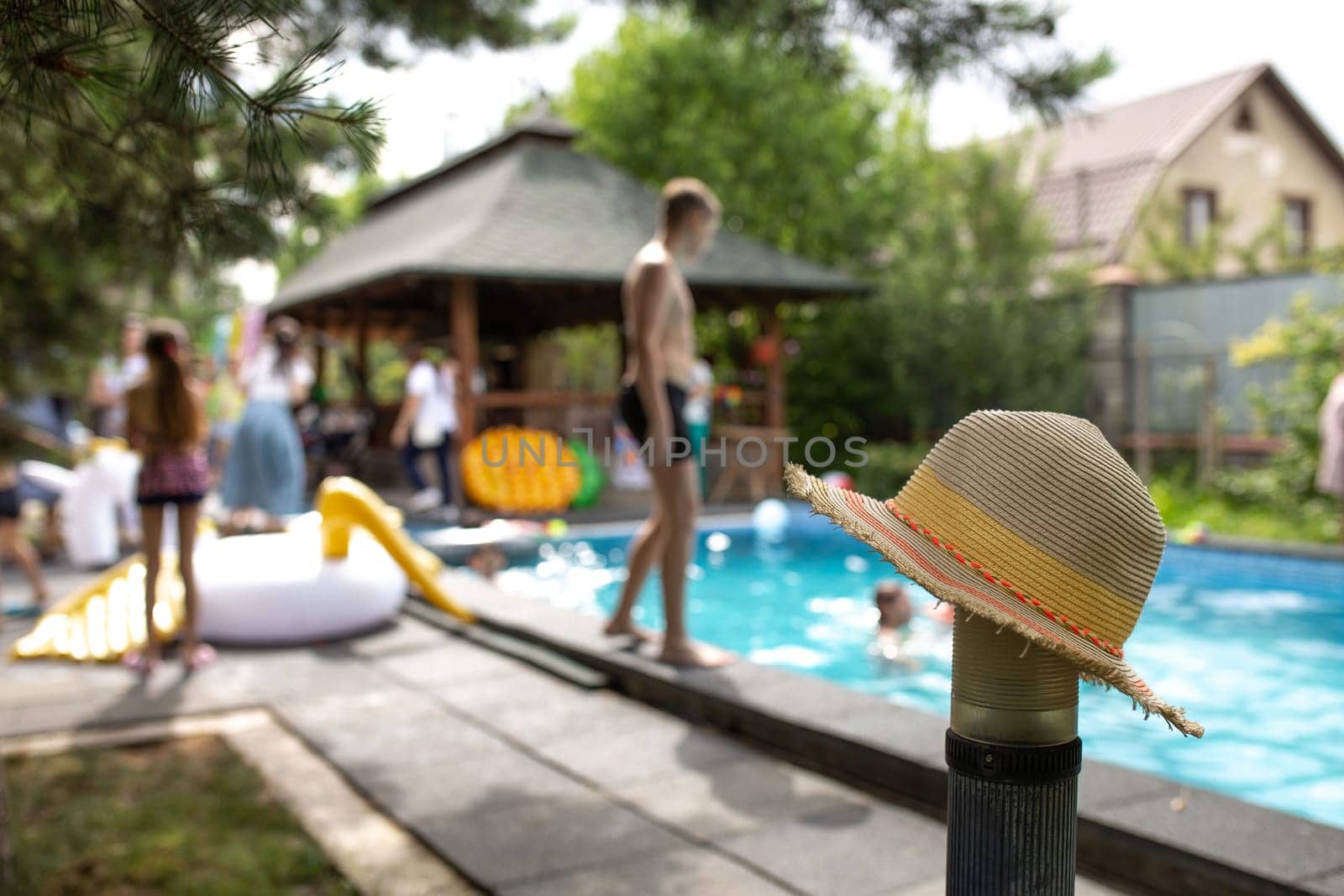 hat on the background of a pool party.