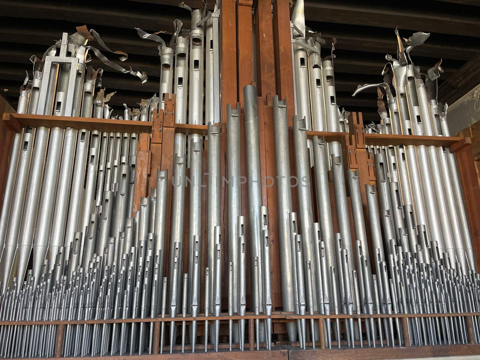 The organ is the largest brass keyboard musical instrument, consisting of a set of pipes into which air is pumped. High quality photo
