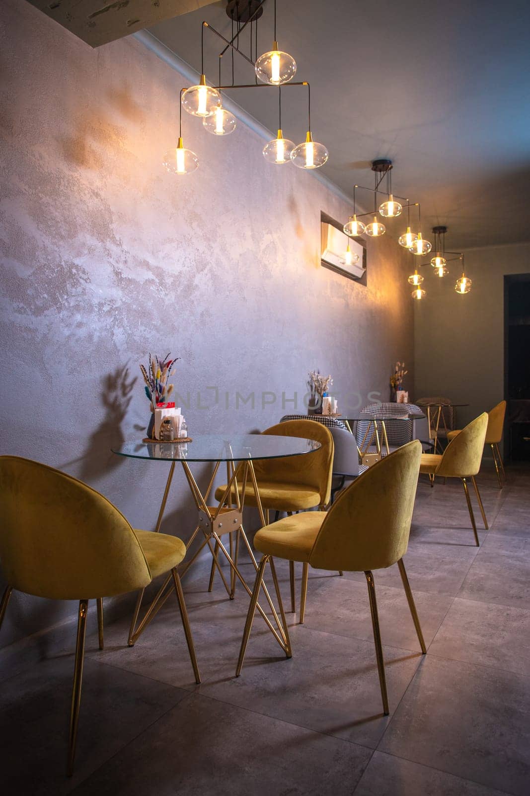 Modern restaurant interior with round tables and yellow chairs by Pukhovskiy