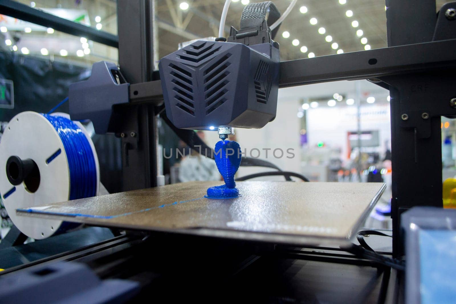 3D printer working close-up 3D printer prints a model from molten yellow plastic by Mari1408