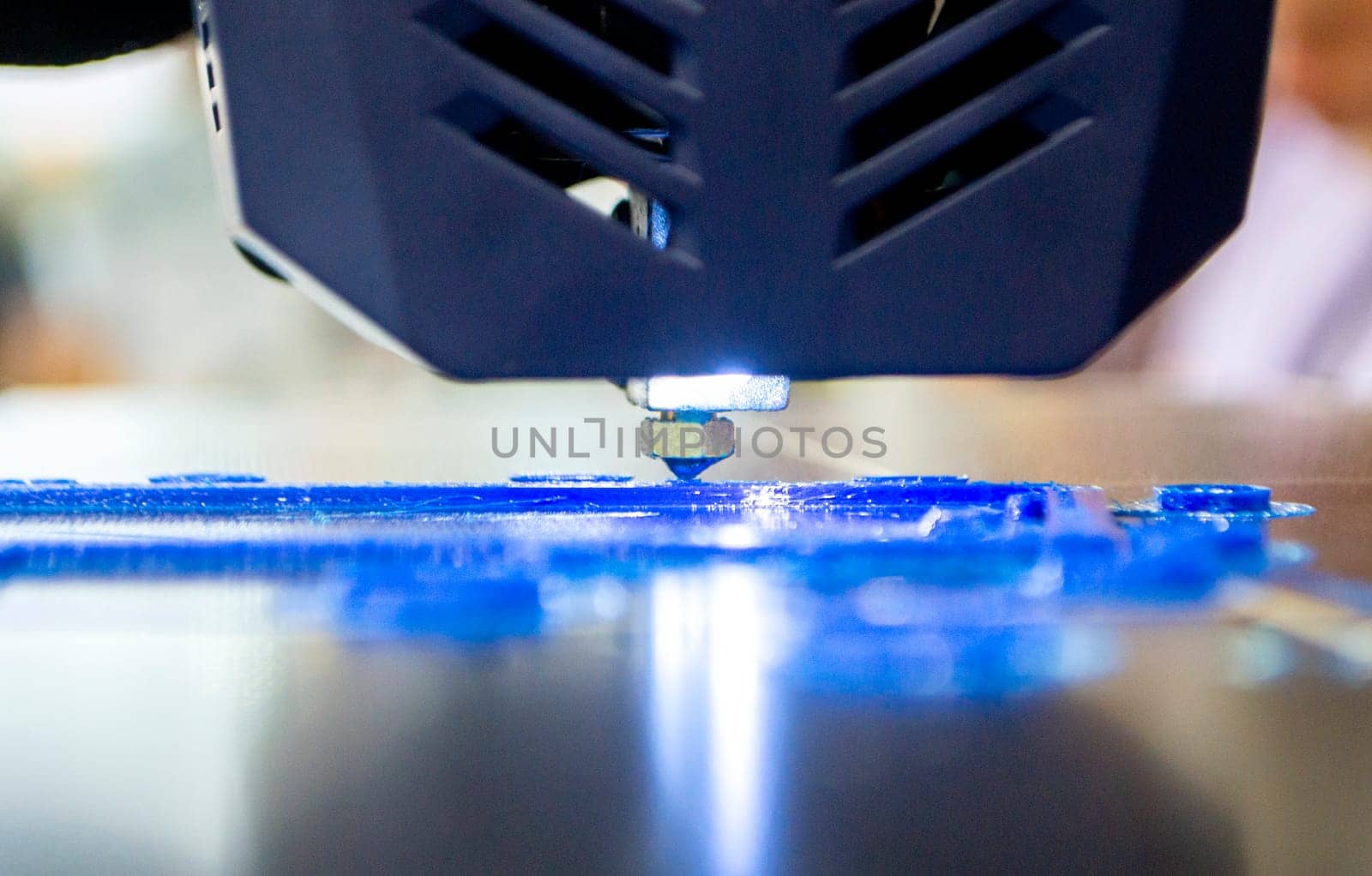 3D printer working close-up 3D printer prints a model from molten yellow plastic by Mari1408