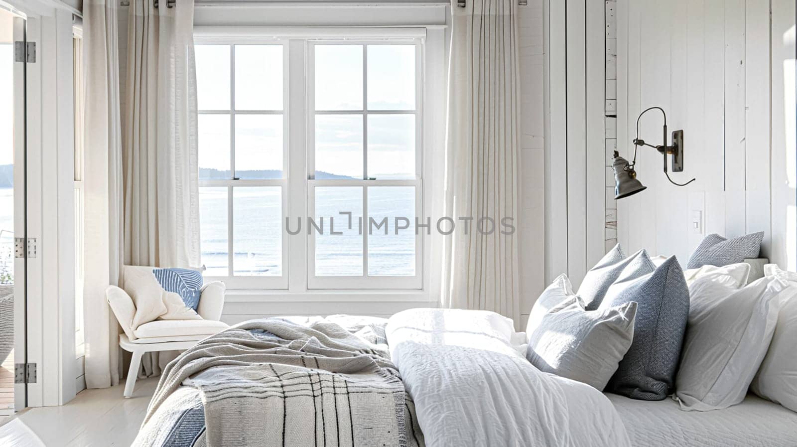 Beautiful interior of luxury bedroom with window sea view. Coastal cottage concept by Olayola