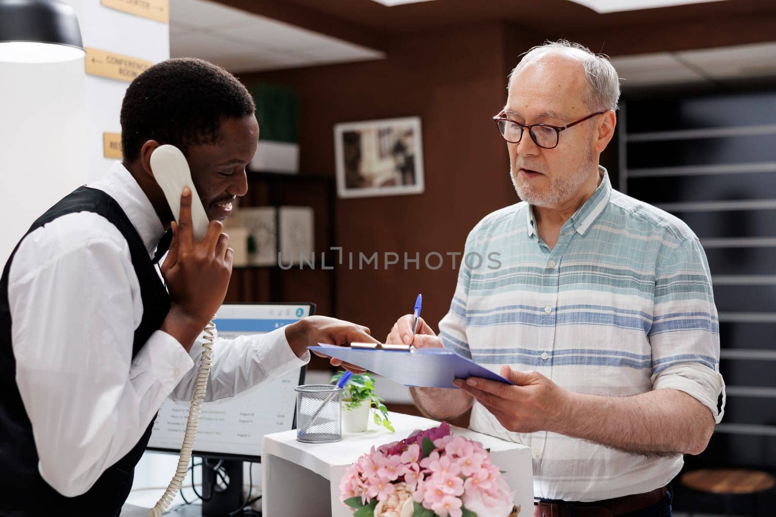 Front Desk: Assisting a Guest Check-In by DCStudio