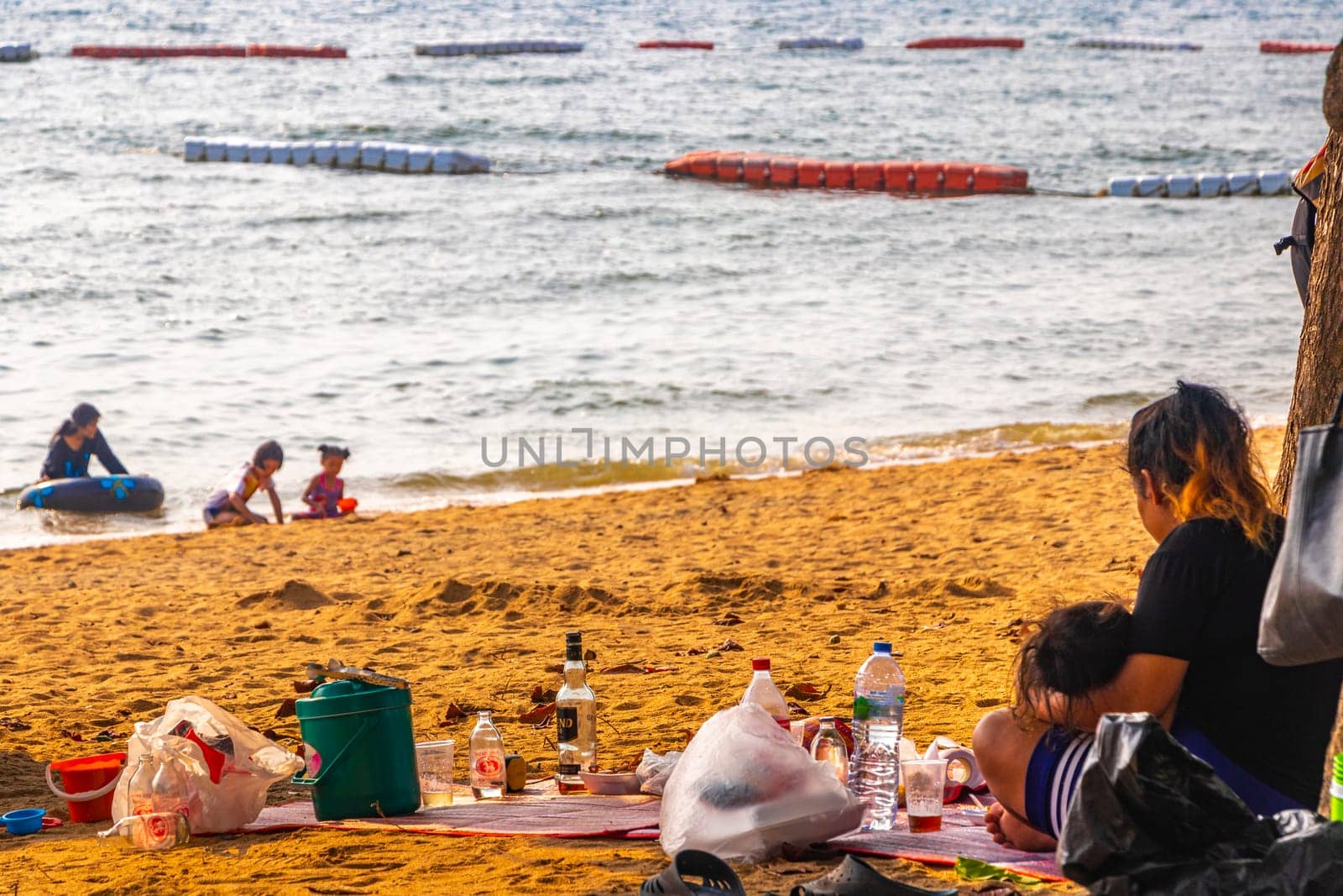 Pattaya Chon Buri Thailand 25. October 2018 Tropical beach waves water sand people boat palm trees and skyscrapers in Jomtien Beach Pattaya Bang Lamung Chon Buri Thailand in Southeastasia Asia.