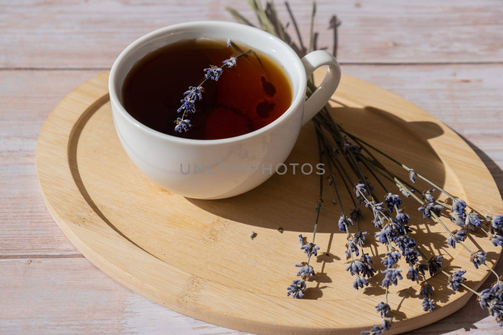 Lavender flowers with herbal cup of tea. Concept of Herbal medicine natural remedy. Organic relieving stress. Healthy beverage fresh delicious floral hot tea. Antispasmodic effect naturopathy concept