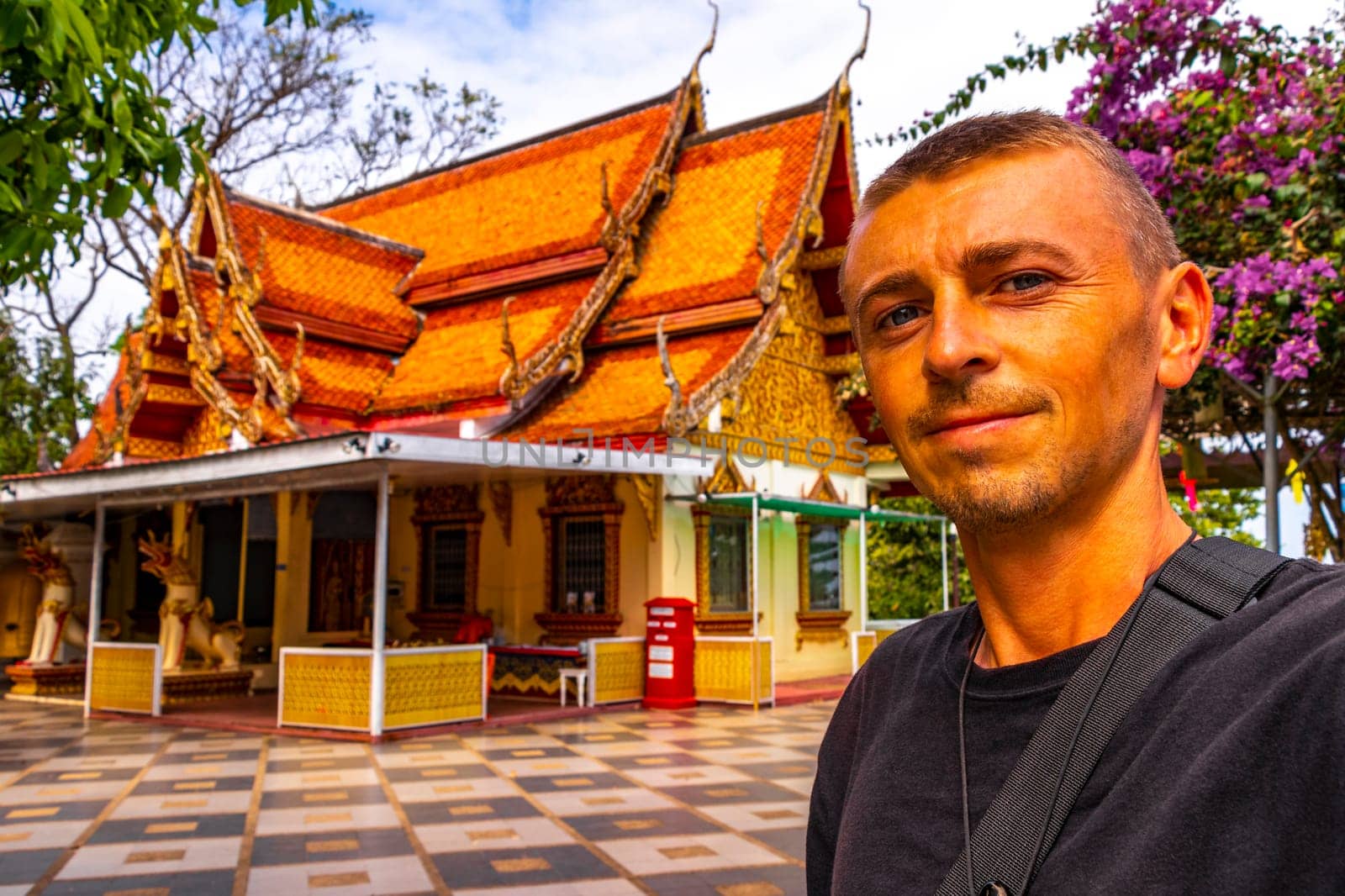 Handsome man male tourist at golden gold Wat Phra That Doi Suthep temple temples building in Chiang Mai Amphoe Mueang Chiang Mai Thailand in Southeastasia Asia.