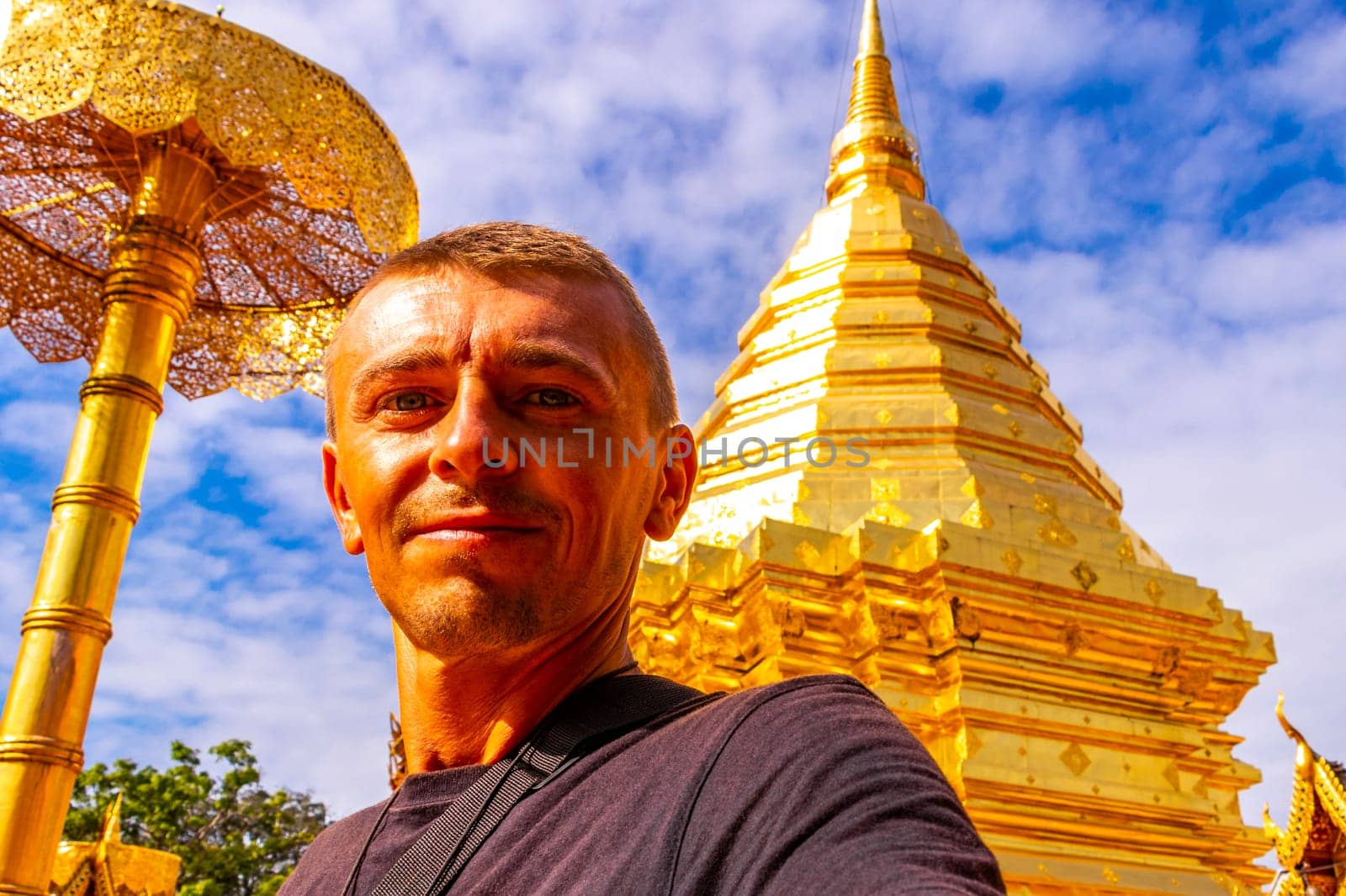 Handsome man male tourist at golden gold stupa pagoda Wat Phra That Doi Suthep temple temples building in Chiang Mai Amphoe Mueang Chiang Mai Thailand in Southeastasia Asia.