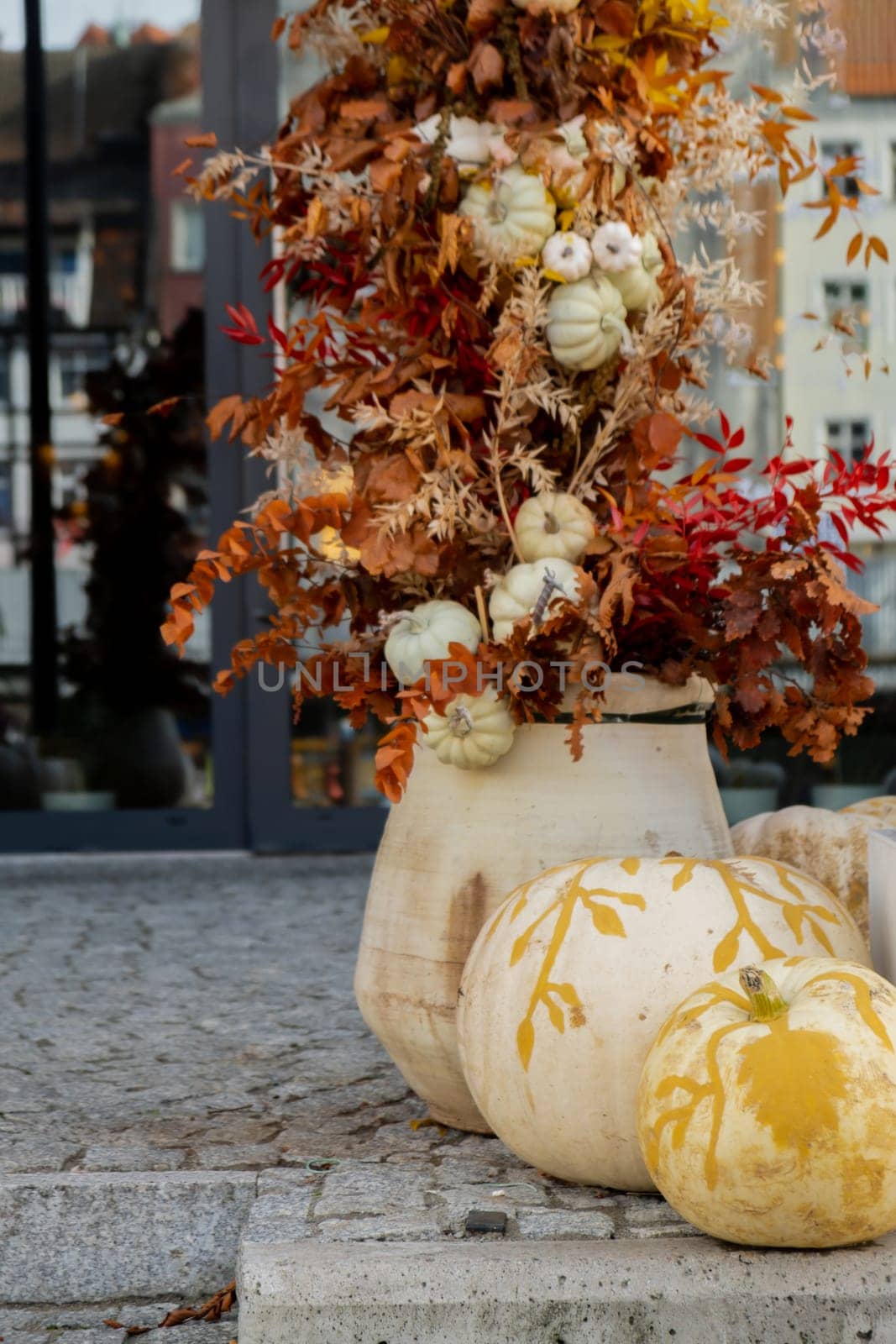 Halloween decorated outdoor cafe or restaurant terrace in America or Europe with pumpkins traditional attributes of Halloween. Frontyard decoration for party.