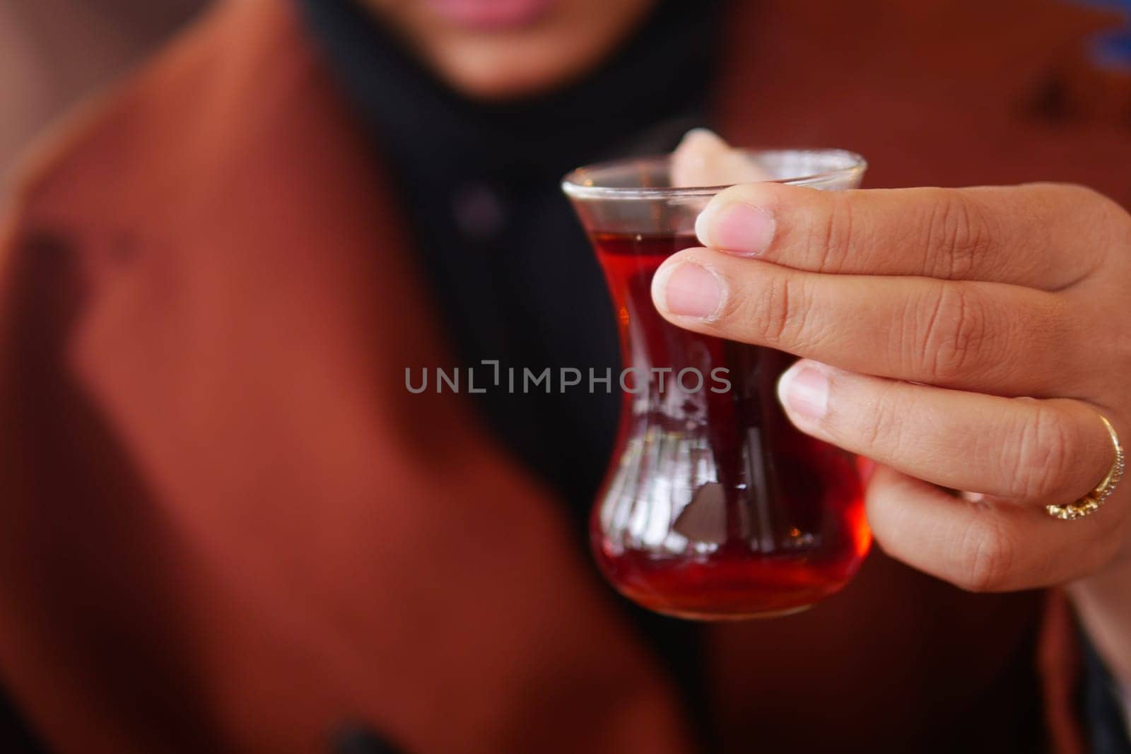 woman drinking Traditional turkish tea on white table . by towfiq007