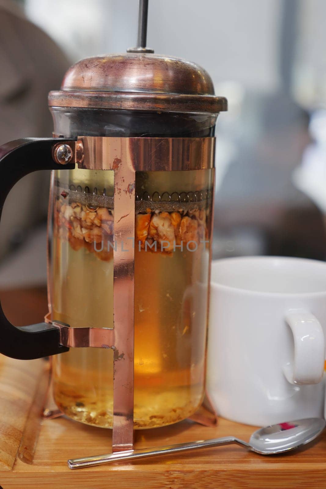 Tableware set with French press, cup, and spoon for serving tea at home,