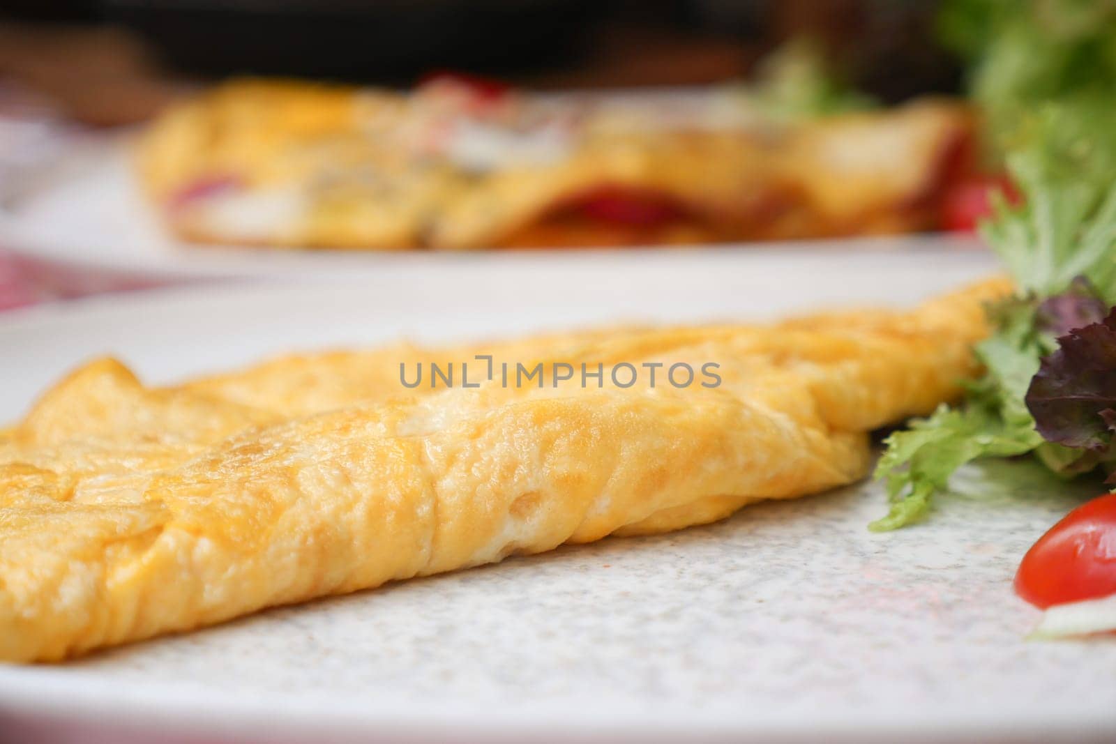 Closeup of Plain Egg Omelette served with herbs on a plate by towfiq007