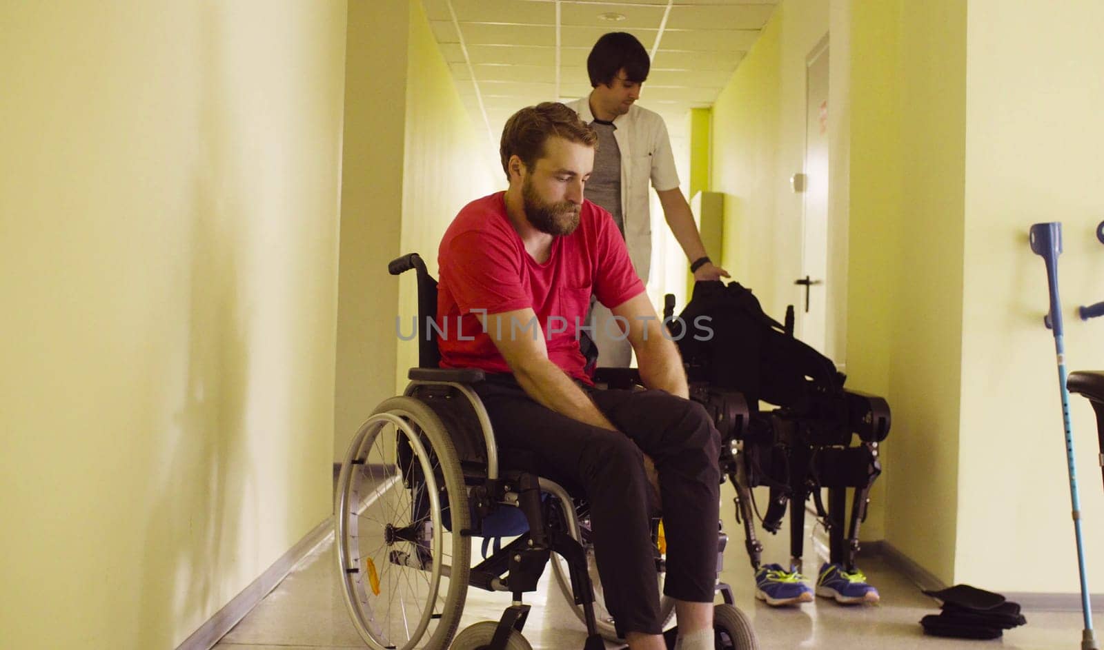 Young disable man sitting in wheelchair in the rehabilitation clinic