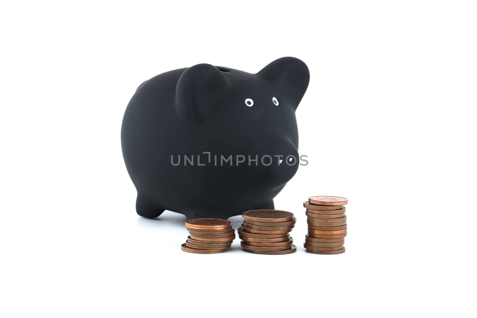 Black piggy bank and stacks of coins isolated on white by NetPix