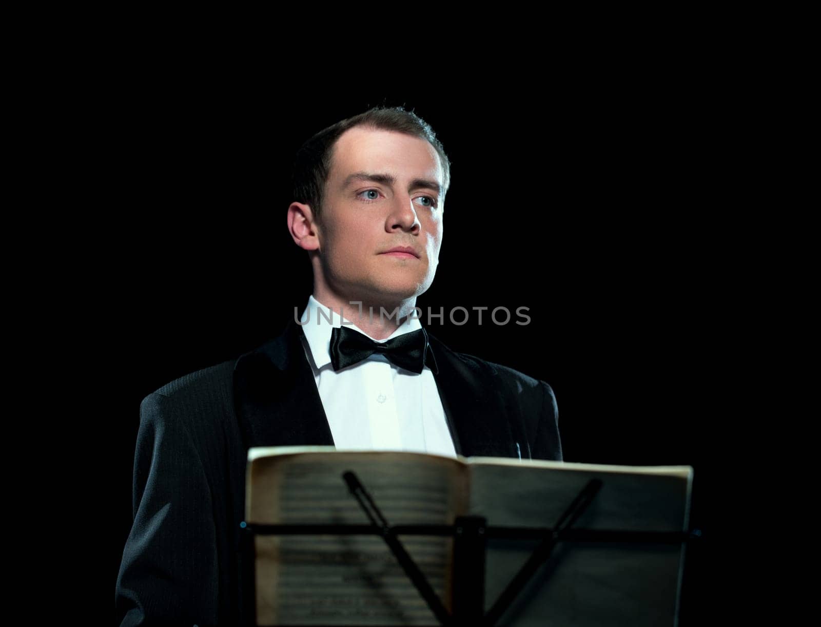 Studio portrait of young man conducts the orchestra
