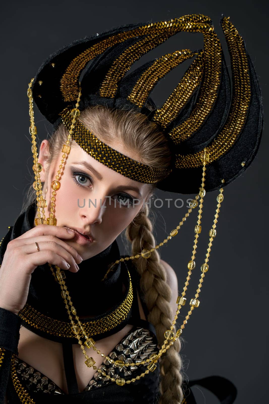 Studio portrait of beautiful go-go dancer in headdress