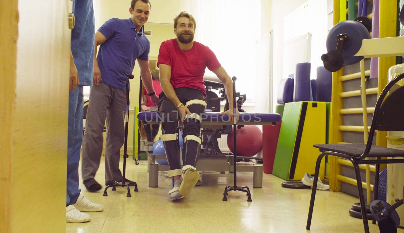 Invalid in orthosis ready to walk with support of two walking cane by Chudakov