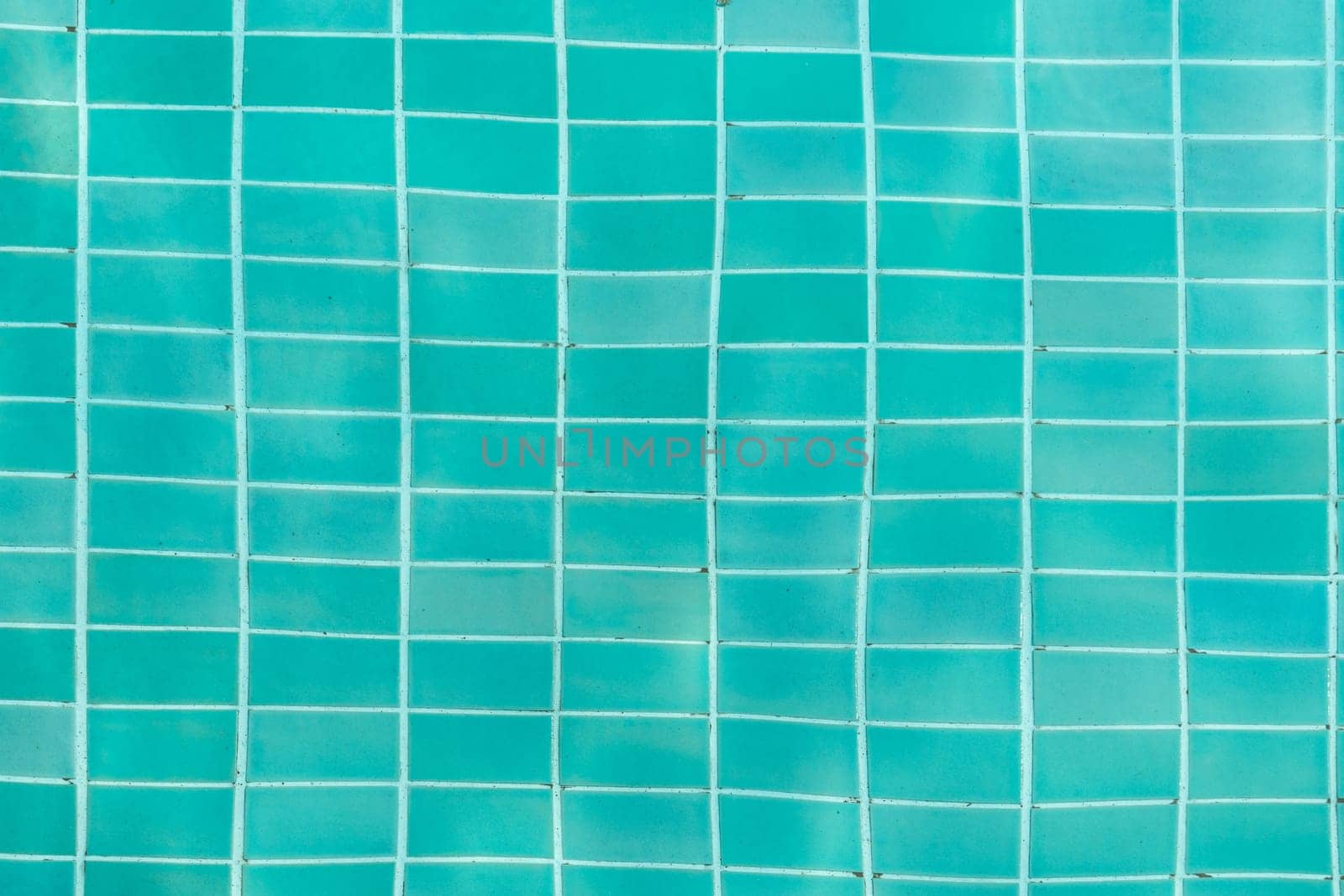 Turquoise swimming pool water surface and ripple wave background. Summer abstract reflection caustics in swimming pool. by kaisorn