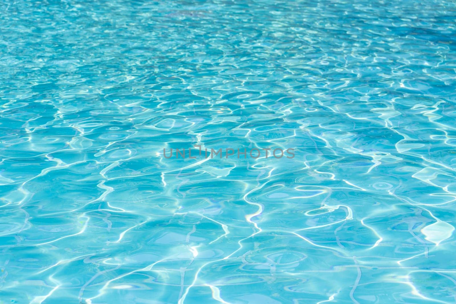 Blue swimming pool water surface and ripple wave background. Summer abstract reflection caustics in swimming pool. by kaisorn