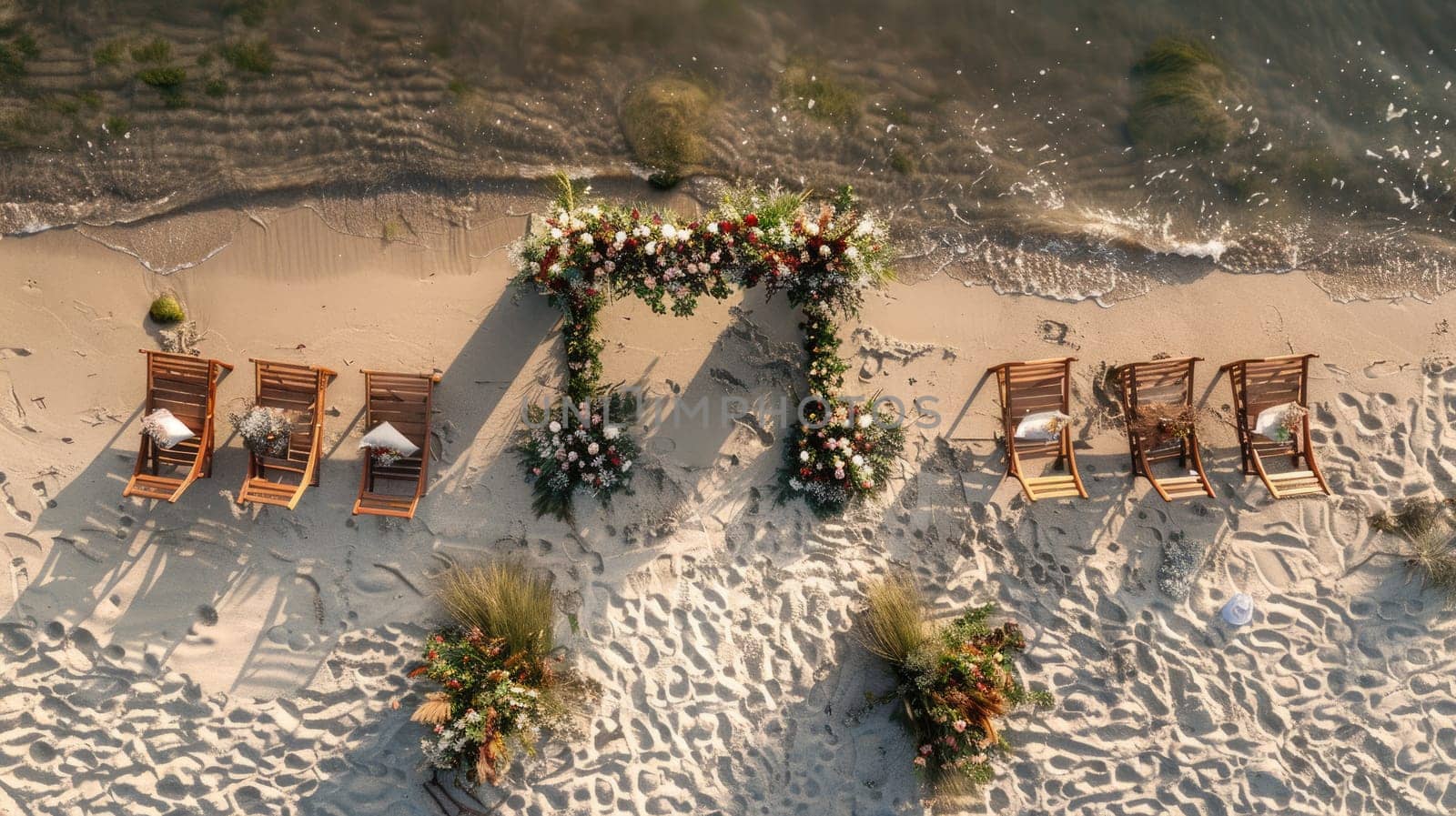 An aerial view of a beach wedding ceremony with chairs and flowers overlooking the water, surrounded by nature and plantfilled landscape AIG50