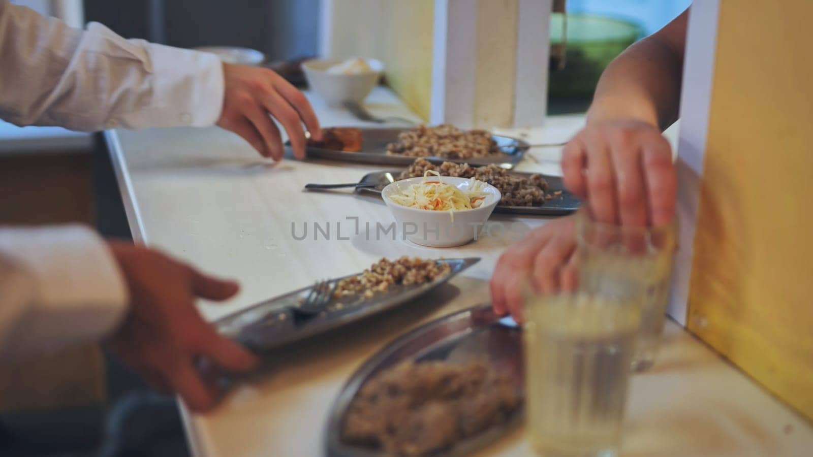 Schoolchildren put down uneaten food in the canteen. by DovidPro