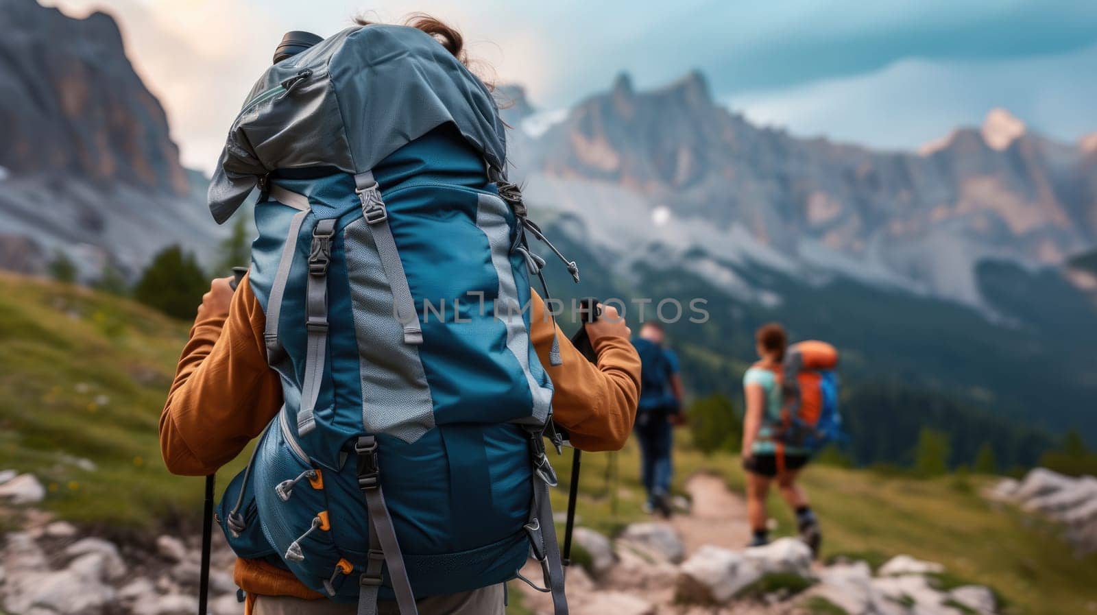 A bunch of backpackers are trekking up the majestic mountain, surrounded by the vast natural landscape, enjoying the sky, plants, and soil along the way. AIG41