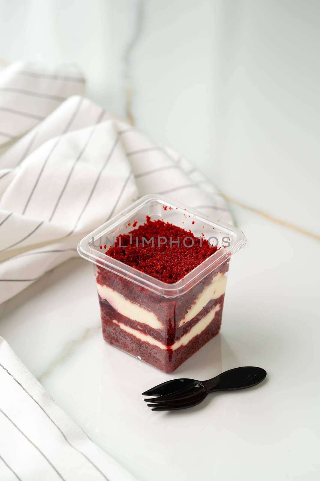 Trifle red velvet in plastic cup on table by Fabrikasimf